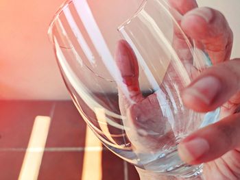 Close-up of hand holding glass of wine