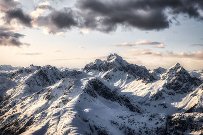 Scenic view of snowcapped mountains against sky during sunset