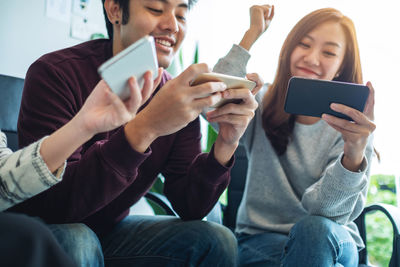 Midsection of woman using mobile phone
