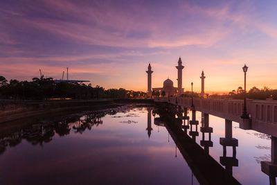 Reflection of temple in lake at sunset