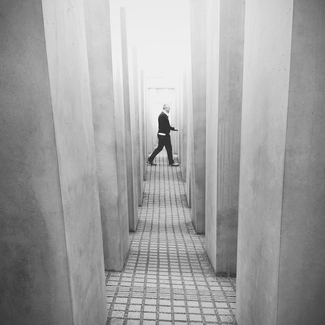 the way forward, architecture, rear view, built structure, walking, full length, lifestyles, men, building exterior, person, corridor, leisure activity, walkway, standing, wall - building feature, day, diminishing perspective, narrow