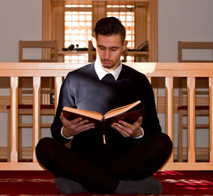 Young man sitting at home