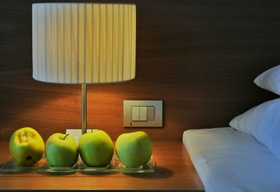 Green apples on a nightstand