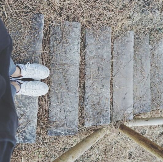 low section, abandoned, standing, lifestyles, old, shoe, day, built structure, person, part of, architecture, indoors, wall - building feature, men, damaged, dirty, obsolete