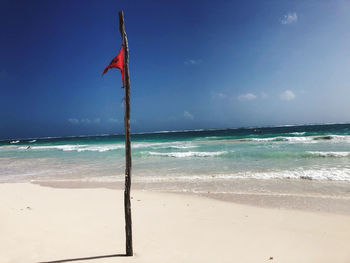 Lifeguard hut on beach against sky