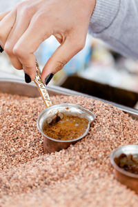 Traditional turkish, arabic coffee brewed in small copper cups in hot sand. close up shot