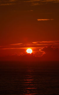 Scenic view of sea against romantic sky at sunset