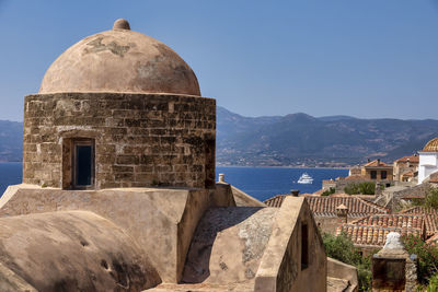 Castle by sea against clear sky