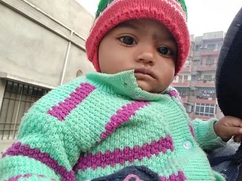 Close-up portrait of cute baby girl in snow