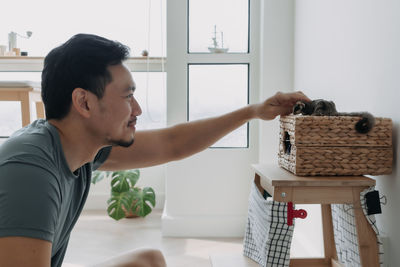 Side view of man washing hands