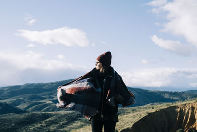 Man standing on mountain against sky