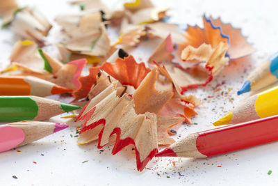 High angle view of multi colored pencils and shavings on table