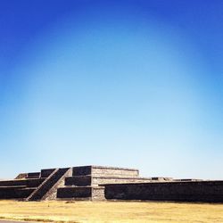 Low angle view of built structure against clear blue sky