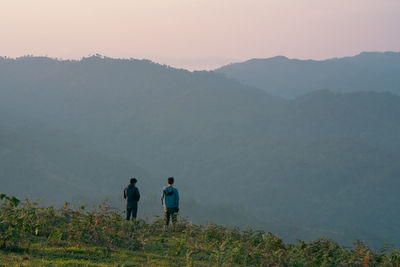 Group of hiker man relax with wellbeing and happy feeling on top of mountain