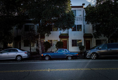 Cars on street by buildings in city