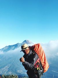 Man standing on mountain against sky