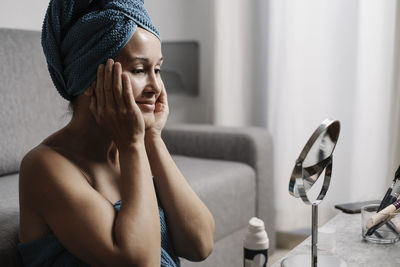 Midsection of woman sitting at home