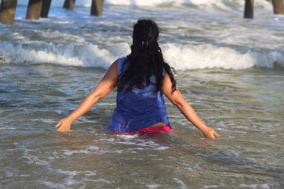 Rear view of woman at beach