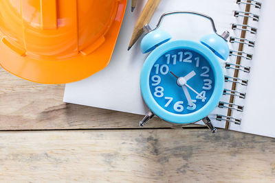 High angle view of clock on table