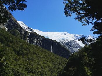 Scenic view of snowcapped mountains against clear sky