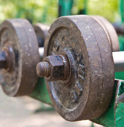 Close-up of rusty dumbbells on rack