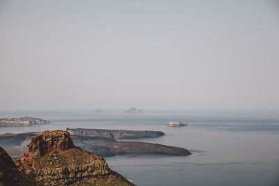 Scenic view of sea and mountains against clear sky on sunny day