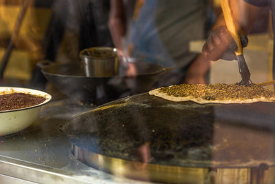 Close-up of man preparing food at stall