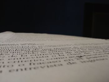 Close-up of text on book against black background