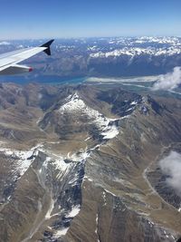 Aerial view of airplane wing over landscape