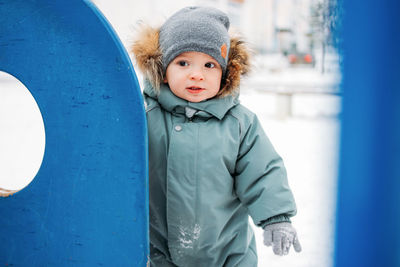 Cute girl standing outdoors during winter