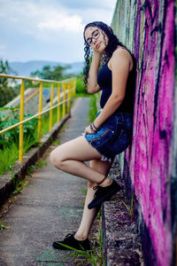 Full length of woman sitting outdoors