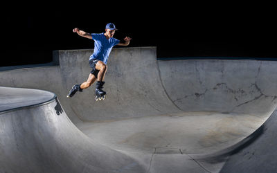 Young man practicing inline skating at skateboard park