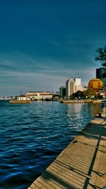 Calm sea with buildings in background