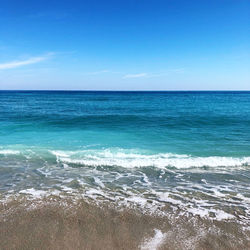 Scenic view of sea against blue sky