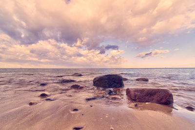 Scenic view of beach against sky during sunset