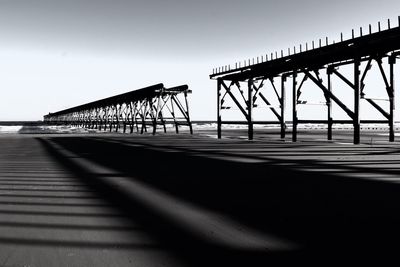 Bridge over sea against clear sky
