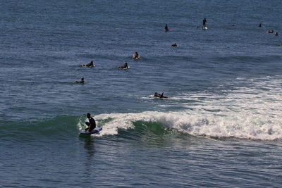 People swimming in sea