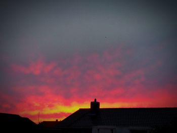 Silhouette of building against sky during sunset