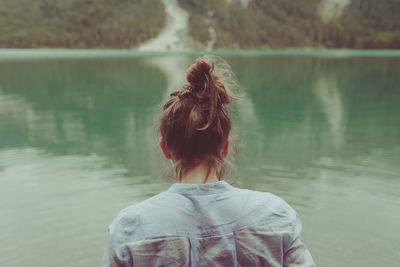 Rear view of woman looking at lake