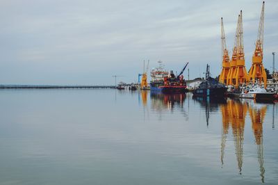 Commercial dock by sea against sky