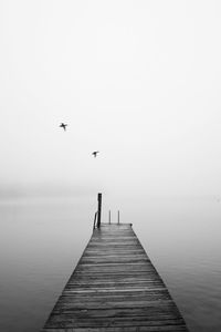 View of jetty leading to sea