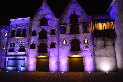 Low angle view of illuminated building at night