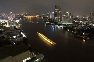 High angle view of city lit up at night