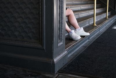 Low section of person sitting on steps