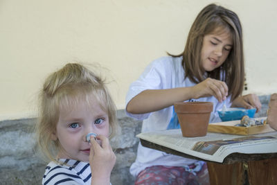 Portrait of smiling young woman having food at home