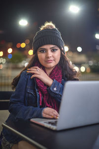 Portrait of young woman using mobile phone