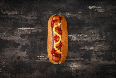 Directly above shot of hot dog on rustic table