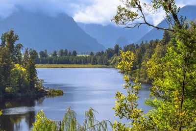 Scenic view of lake and mountains against sky