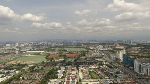 High angle view of cityscape against cloudy sky