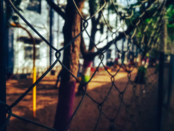 Close-up of barbed wire on chainlink fence